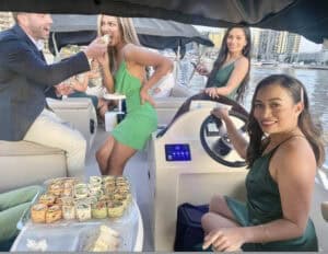 Guests enjoying catering beside the helm of a Spaceship party boat in Melbourne